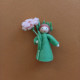Seasonal doll carnation with flowers in her hand